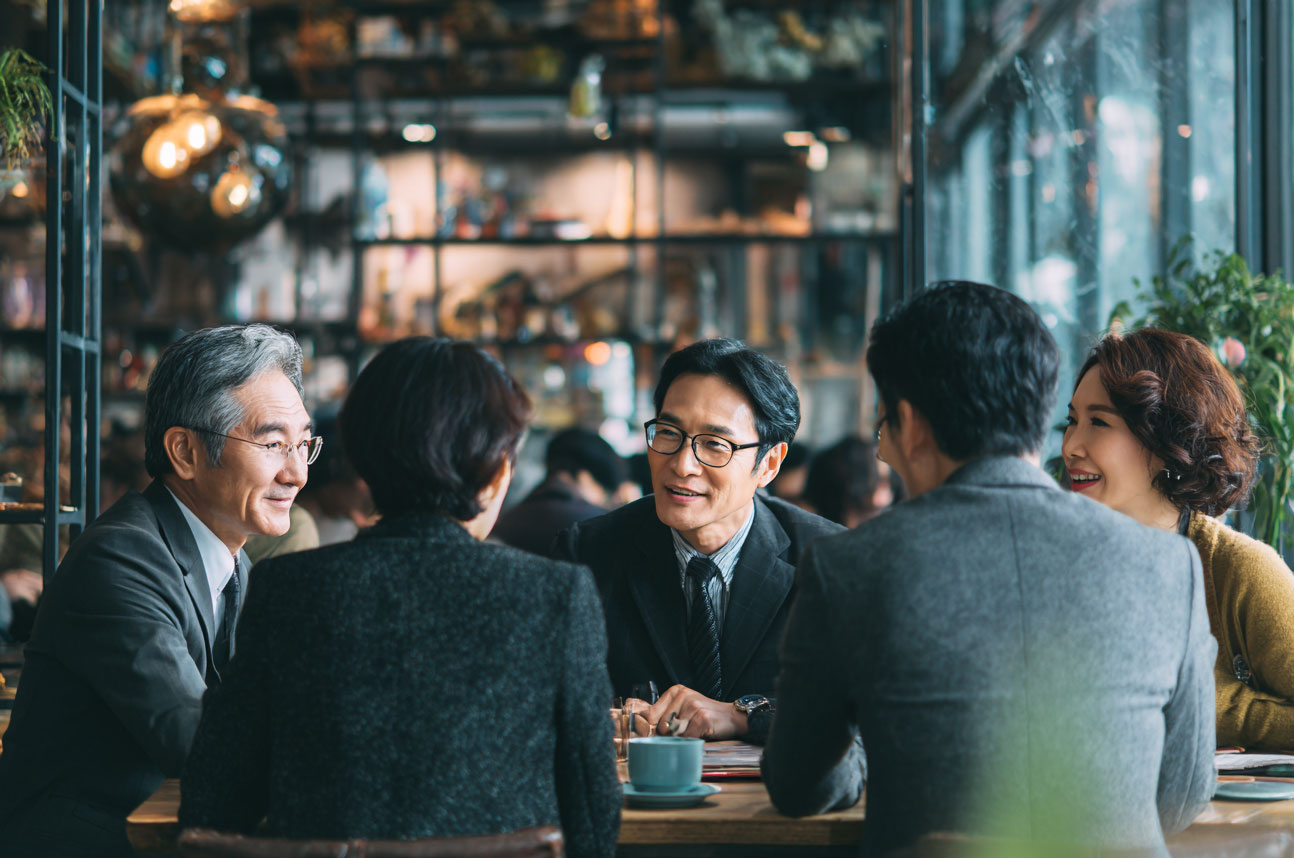 group-of-korean-businesspeople-talking-in-a-cafe group of korean businesspeople talking in a cafe